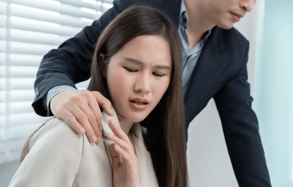 Image of business woman being sexually harassed at work.