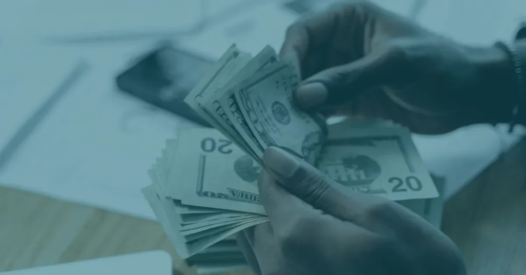 Business owner taking tips from servers