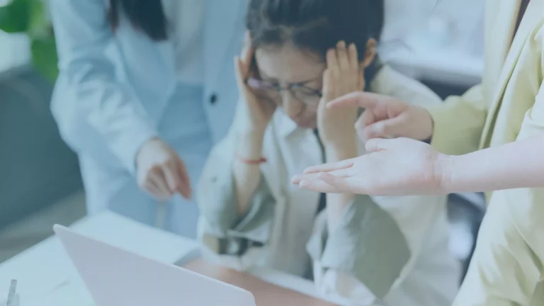 Office worker experiencing coworker harassment, illegal under Oregon law.