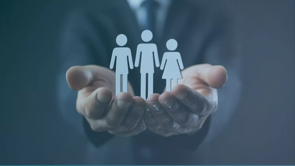 A lawyer holds paper cutouts representing clients who are wrongfully terminated misclassified contractors in Oregon.