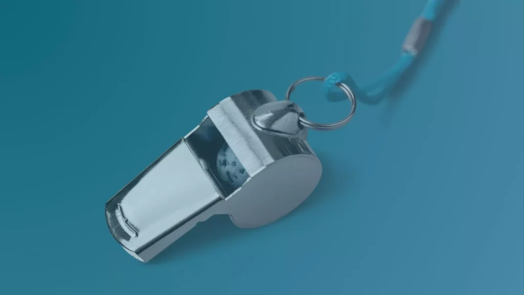 Whistle in foreground symbolizing a qui tam lawsuit.