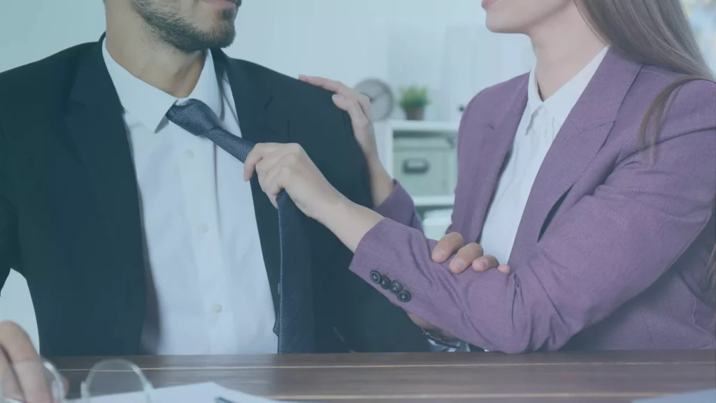 Close-up of workplace sexual advances involving unwanted physical contact, representing quid pro quo sexual harassment in Oregon.