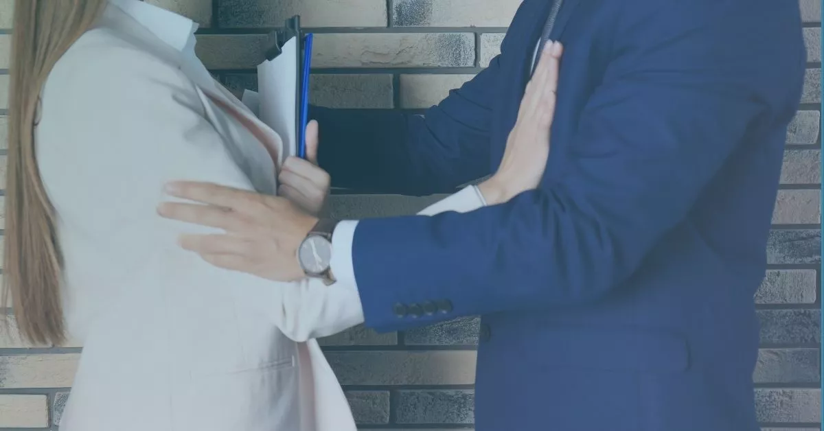 Employee pushing away unwanted physical contact at work, illustrating what quid pro quo sexual harassment can mean.