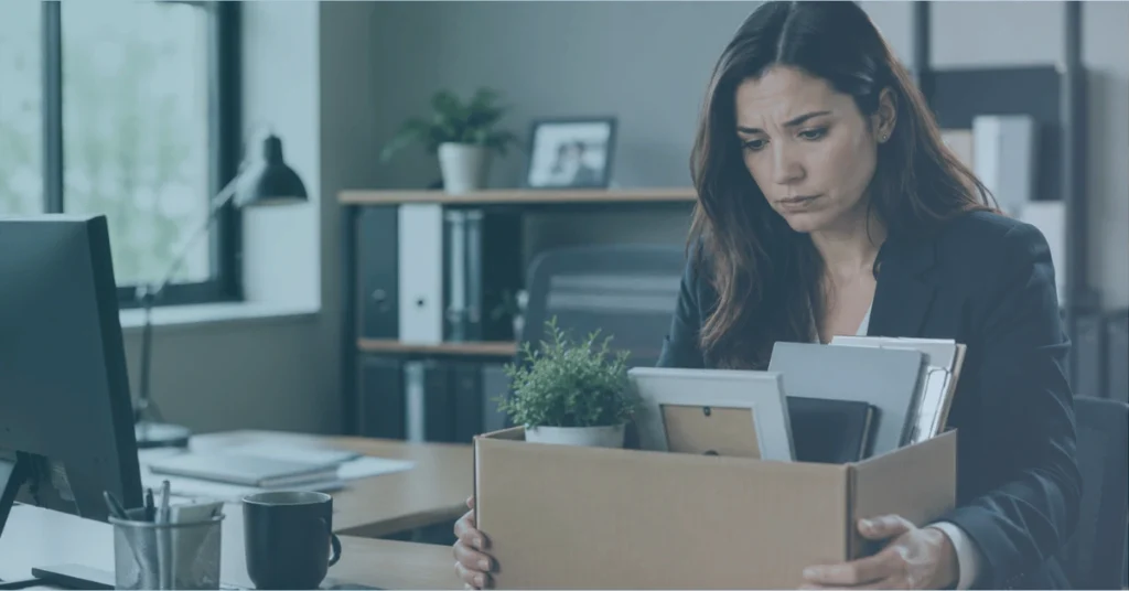 Concerned employee holding a box of office items after termination, illustrating potential FMLA wrongful termination.
