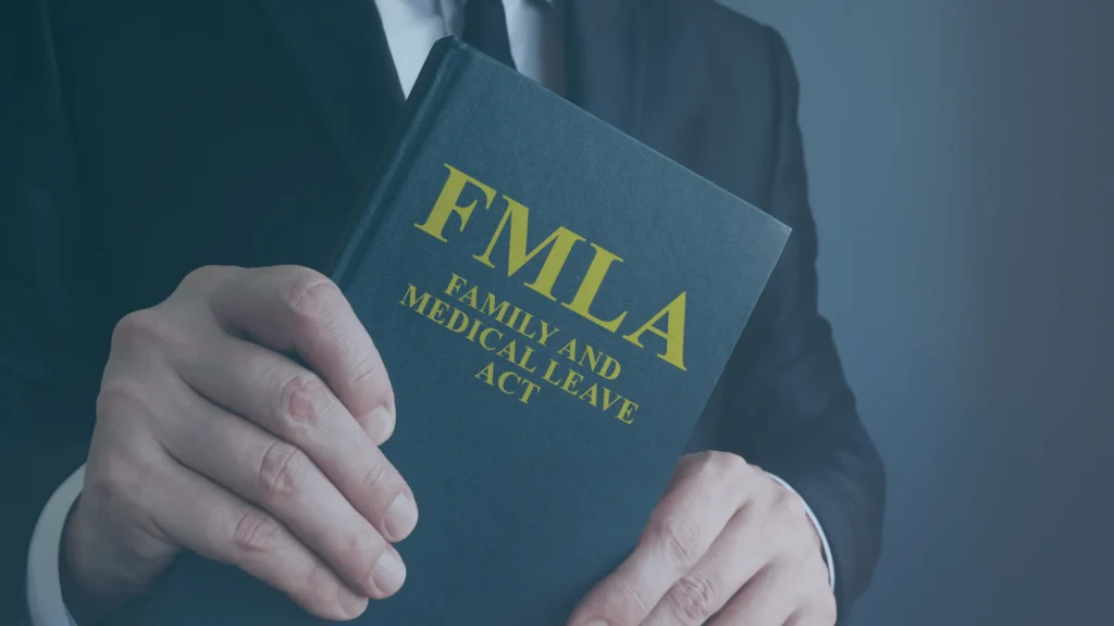 Business professional holding an FMLA Family and Medical Leave Act book, representing FMLA eligibility and leave protections for part-time employees.