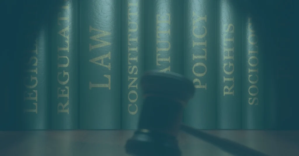 Law books and a judge’s gavel representing Oregon employment laws that may provide protections beyond federal FMLA leave rights.